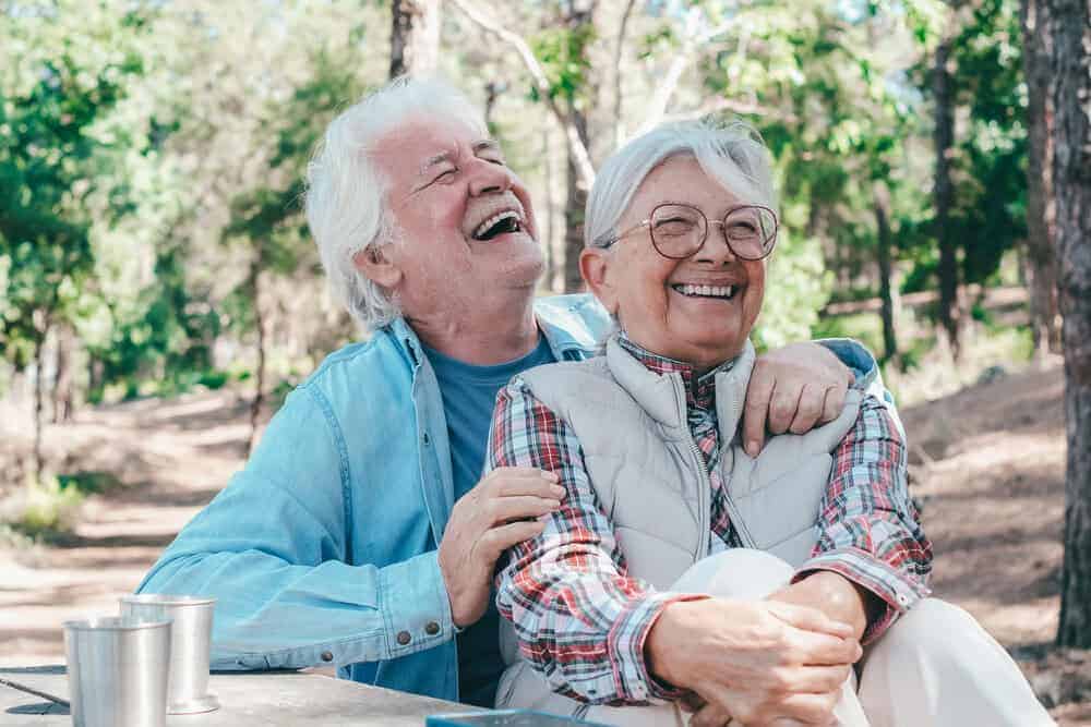 Two happy seniors enjoying a social outing at a park in Carson City.