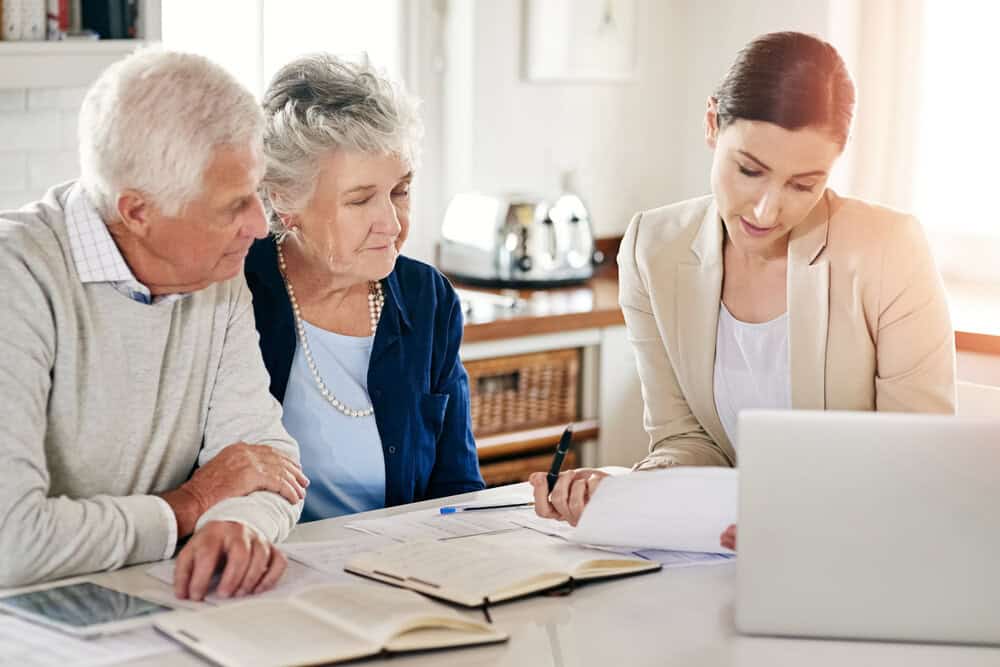 An advisor at Nevada Care Connection helping an elderly couple find transportation resources
